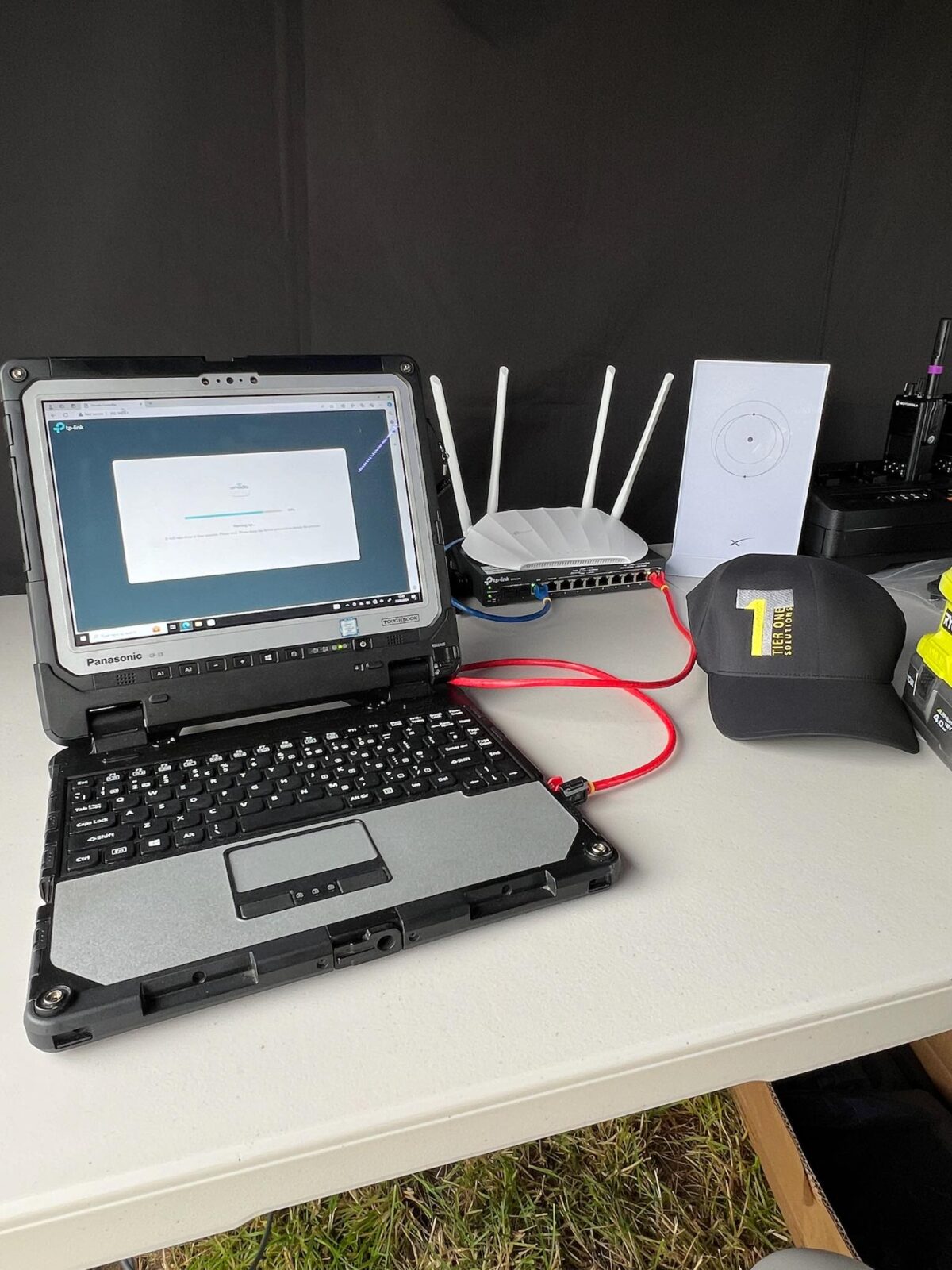 Laptop, radios and antennas set up in a temporary control room