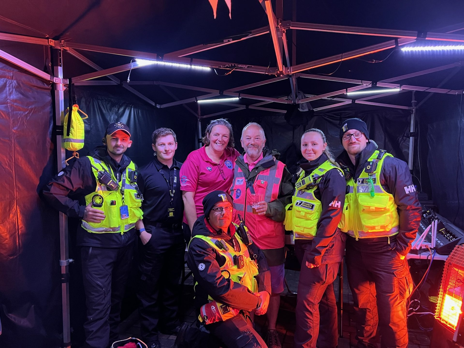 Tier 1 Solutions team on cover at a night-time event